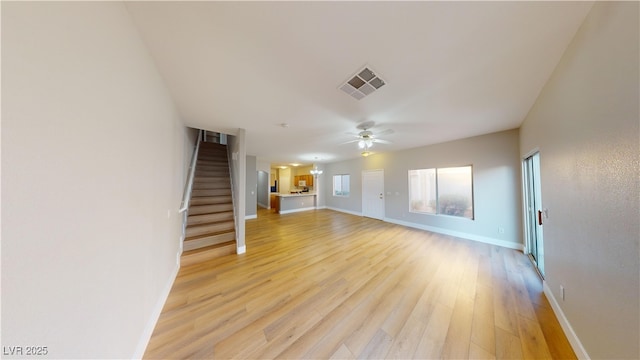 unfurnished living room featuring ceiling fan and light hardwood / wood-style flooring