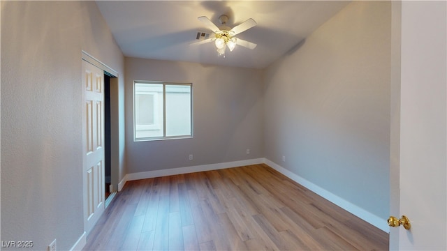 unfurnished bedroom with ceiling fan and light wood-type flooring