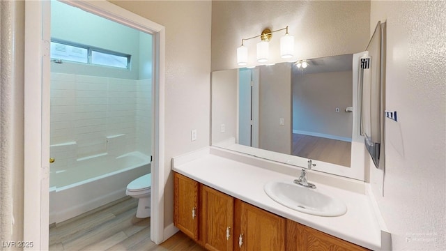 full bathroom featuring hardwood / wood-style flooring, vanity, shower / bathtub combination, and toilet