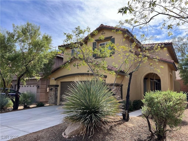 mediterranean / spanish-style house with a garage