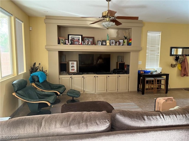 living room with ceiling fan and light colored carpet