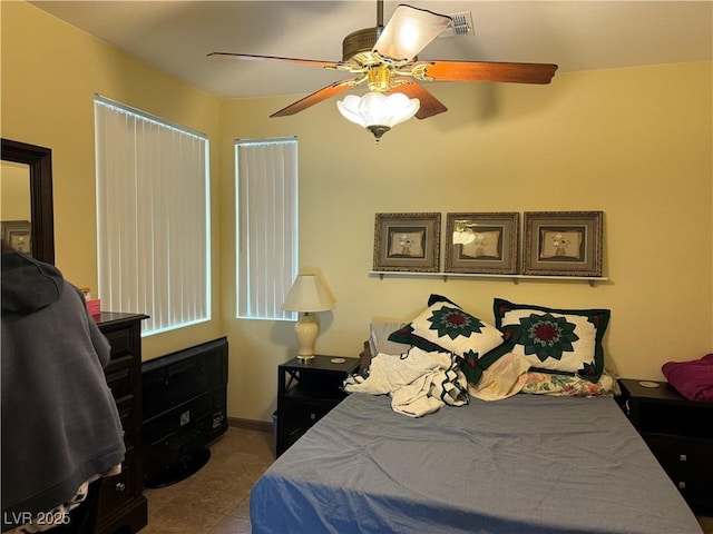 tiled bedroom with ceiling fan