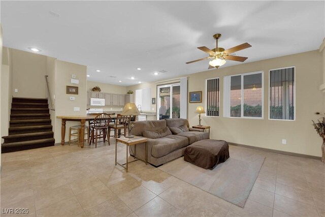 living room featuring ceiling fan and light tile patterned floors