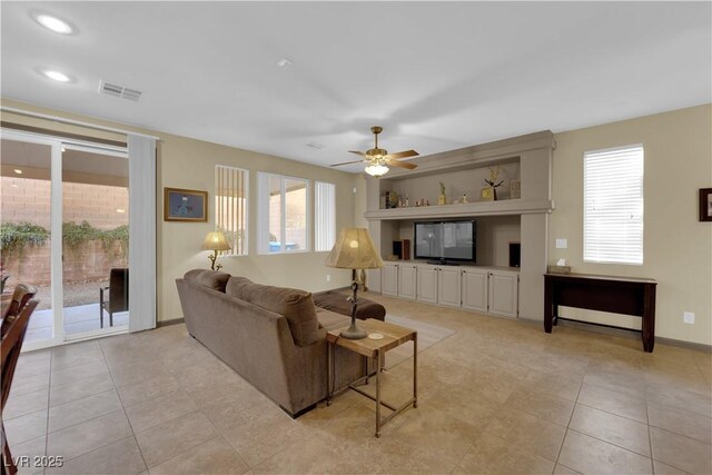 tiled living room featuring ceiling fan