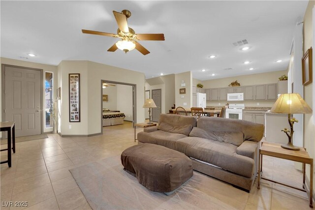 living room with ceiling fan and light tile patterned floors