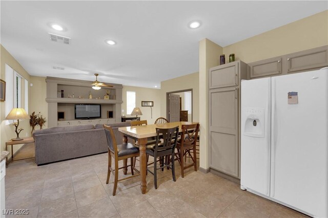 dining room featuring light tile patterned floors and ceiling fan