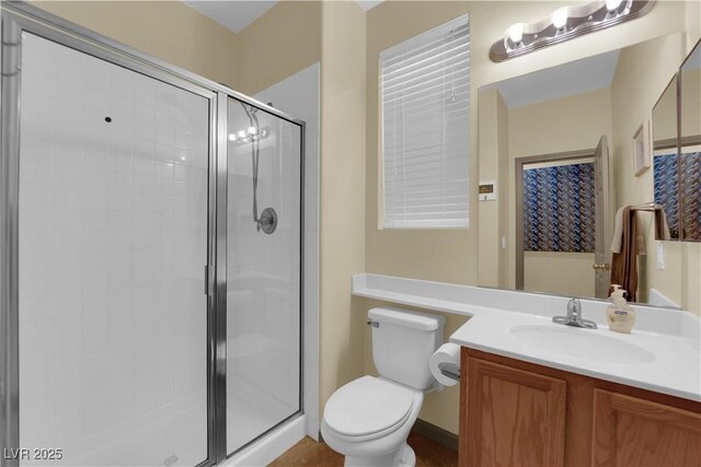 bathroom with vanity, an enclosed shower, and toilet