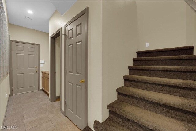 stairway with tile patterned floors