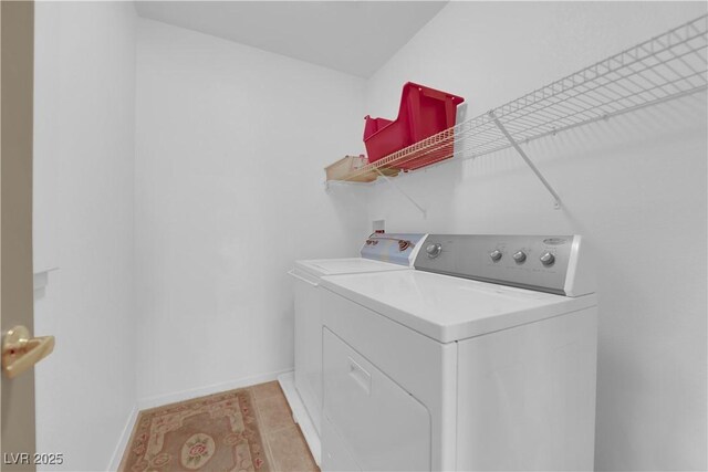 clothes washing area with washing machine and dryer