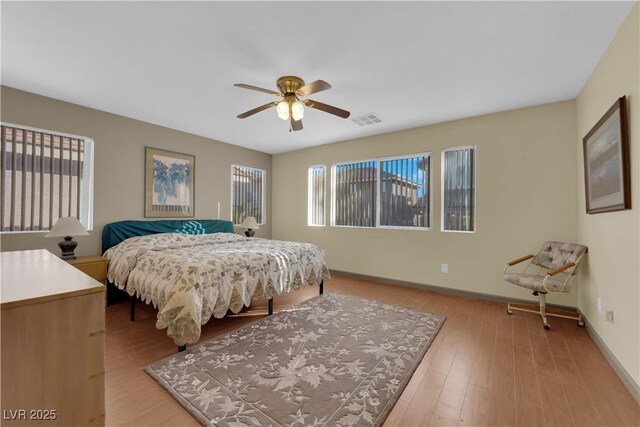 bedroom with ceiling fan and light wood-type flooring