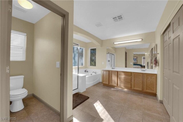 full bathroom with vanity, toilet, tile patterned flooring, and plus walk in shower