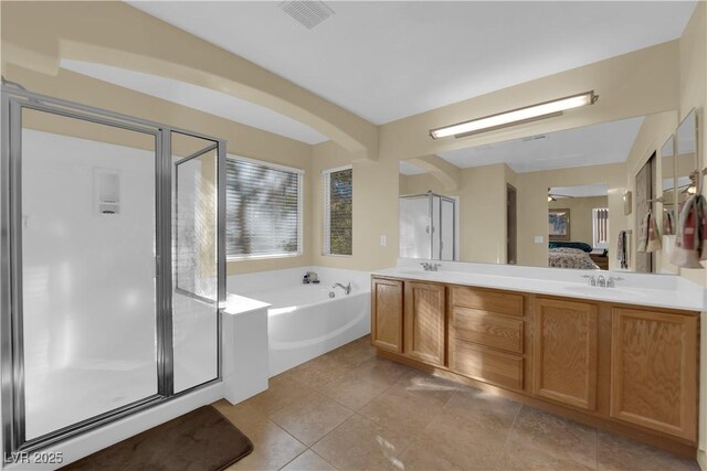 bathroom with tile patterned flooring, plus walk in shower, and vanity