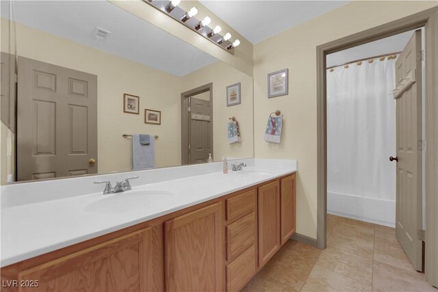 bathroom featuring vanity, tile patterned floors, and shower / bath combo with shower curtain