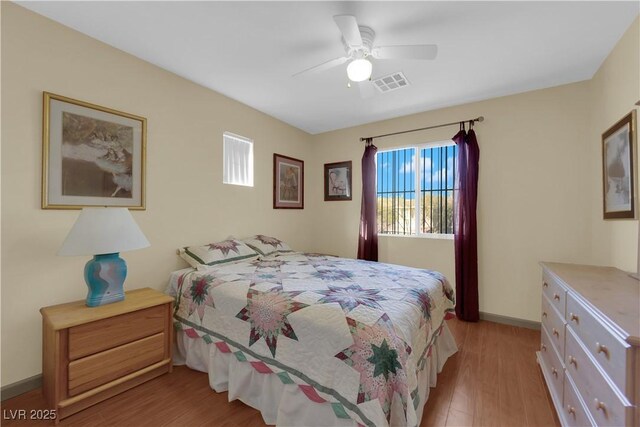 bedroom with ceiling fan and light wood-type flooring