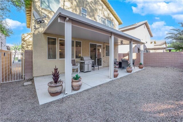 rear view of property featuring a patio and ceiling fan