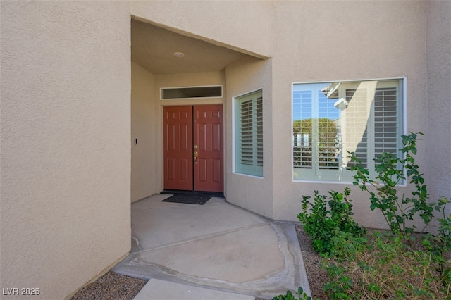 property entrance featuring stucco siding