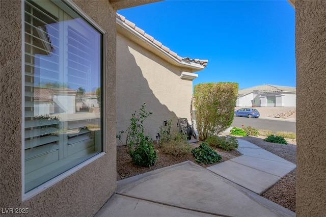 view of home's exterior featuring stucco siding and a tiled roof