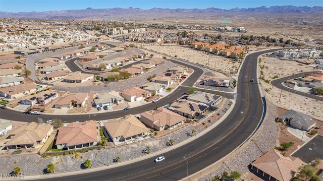 bird's eye view with a residential view, a mountain view, and view of desert