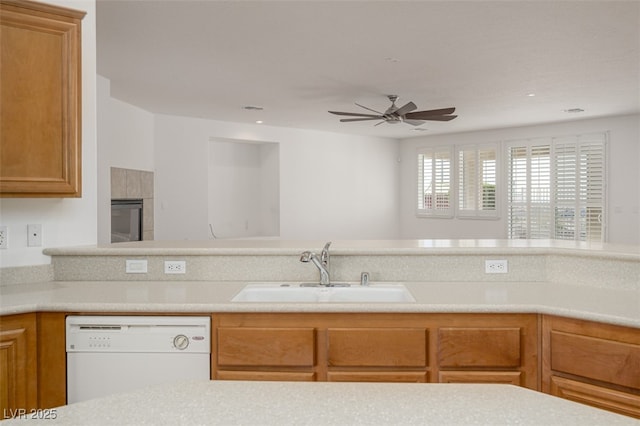 kitchen with dishwasher, ceiling fan, brown cabinets, light countertops, and a sink