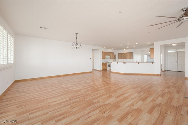 unfurnished living room with light wood-style floors, visible vents, baseboards, and ceiling fan with notable chandelier