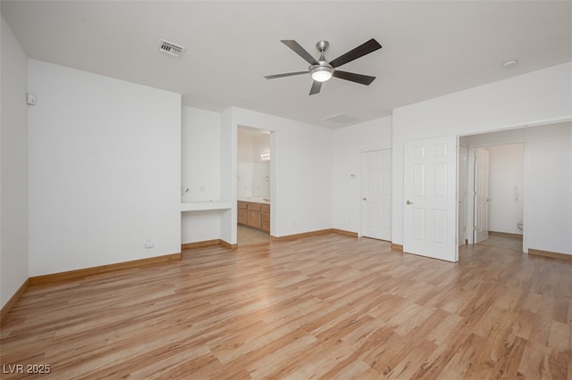 unfurnished bedroom with visible vents, ensuite bathroom, ceiling fan, light wood-type flooring, and baseboards