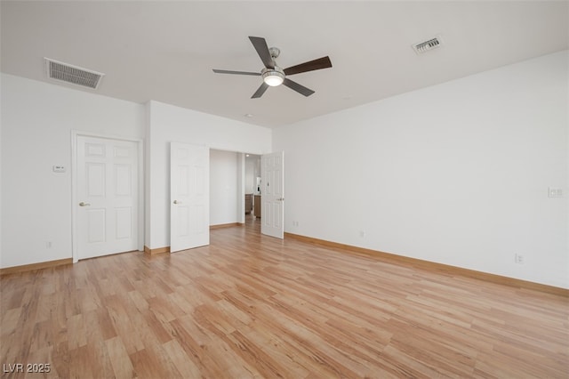 unfurnished bedroom with light wood-style flooring, visible vents, and baseboards