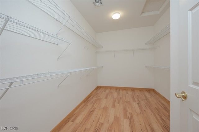 spacious closet featuring light wood finished floors and visible vents