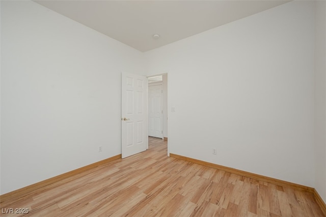 unfurnished room featuring light wood-style flooring and baseboards