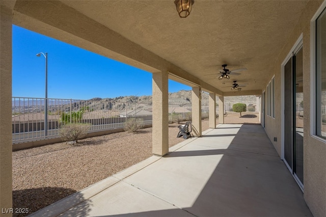 view of patio / terrace featuring fence and a ceiling fan