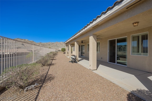 exterior space featuring ceiling fan and a fenced backyard