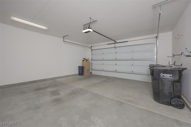 garage with a garage door opener and baseboards