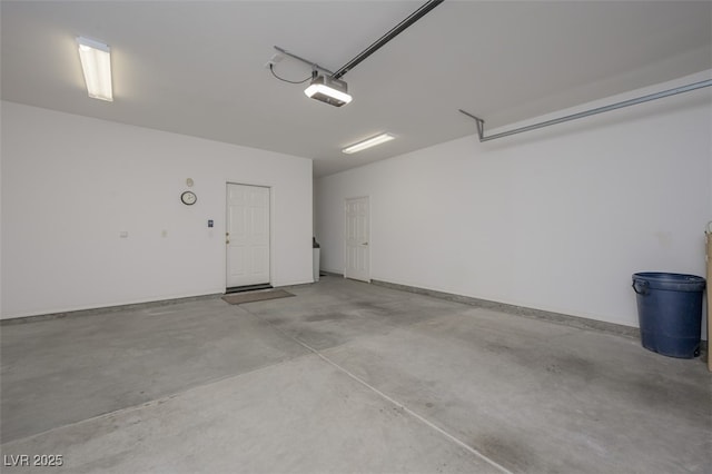 garage featuring baseboards and a garage door opener