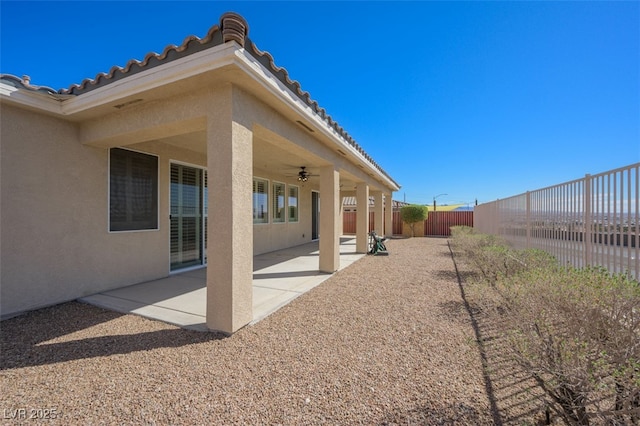 exterior space with ceiling fan, a patio, and a fenced backyard