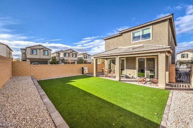 back of house with a yard and a patio