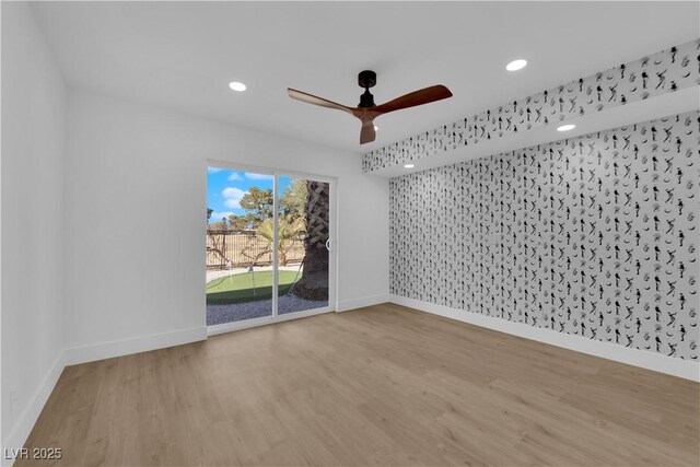 empty room with ceiling fan and light hardwood / wood-style floors