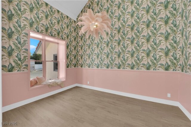 spare room featuring ornamental molding and hardwood / wood-style floors