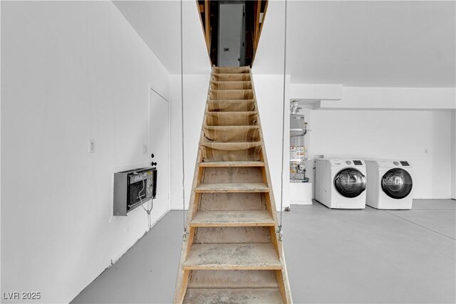 stairs with heating unit, water heater, washer and dryer, and concrete floors