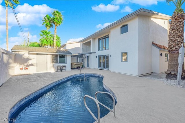 view of swimming pool featuring a patio area and french doors