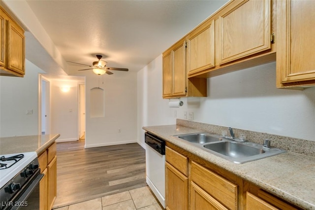 kitchen featuring light brown cabinetry, white appliances, ceiling fan, sink, and light tile patterned floors