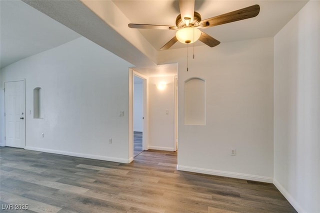 unfurnished room with ceiling fan, wood-type flooring, and vaulted ceiling