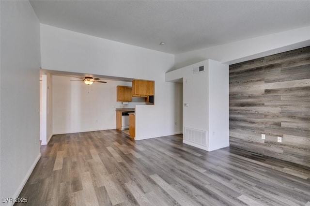 unfurnished living room with hardwood / wood-style floors and ceiling fan