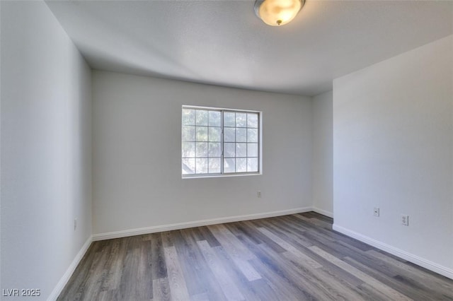 unfurnished room with wood-type flooring