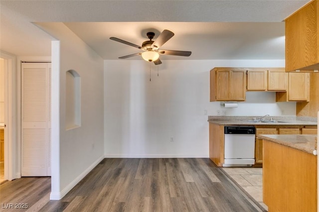 kitchen featuring light brown cabinets, white dishwasher, sink, hardwood / wood-style flooring, and ceiling fan