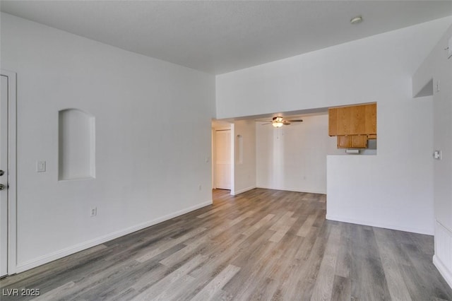 unfurnished living room featuring light hardwood / wood-style flooring and ceiling fan