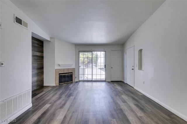 unfurnished living room featuring a fireplace and dark hardwood / wood-style flooring