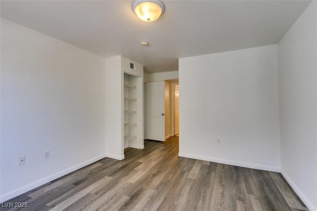 empty room featuring dark hardwood / wood-style flooring