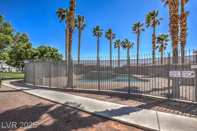 view of gate featuring a community pool