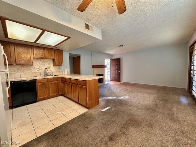 kitchen featuring dishwasher, light carpet, sink, ceiling fan, and kitchen peninsula