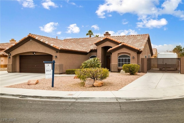 mediterranean / spanish-style house with a garage