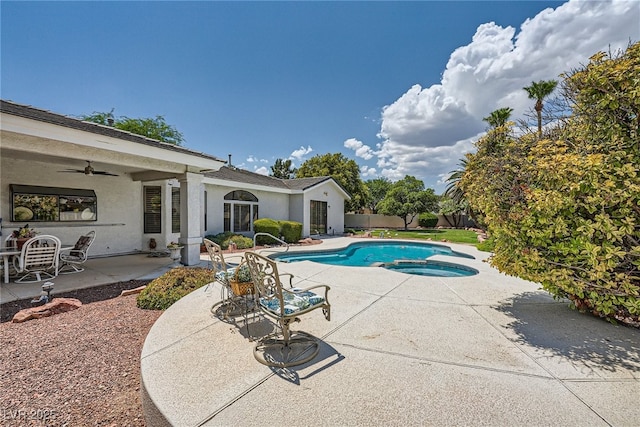 view of pool with a patio area, an in ground hot tub, and ceiling fan